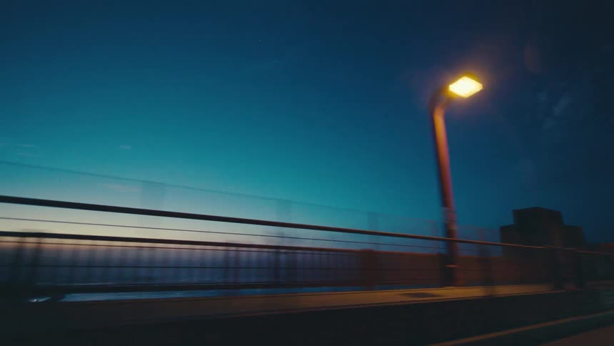 A bridge overlooking the ocean at dusk