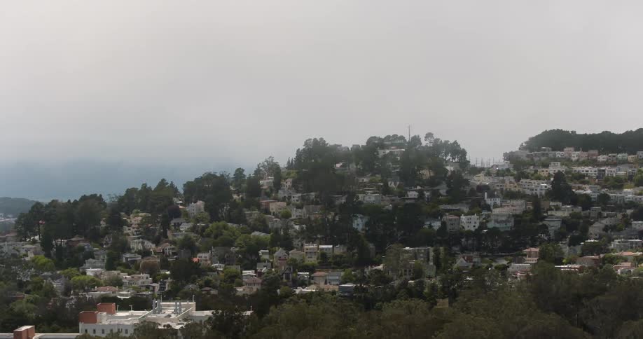 View of a city below a ridge on a very hazy day