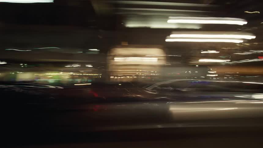 Traffic passing buildings in the city at night