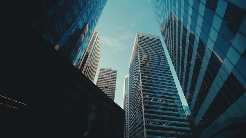 Tall densely packed buildings stand tall under a blue sky