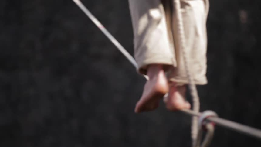 A person balances on a tightrope