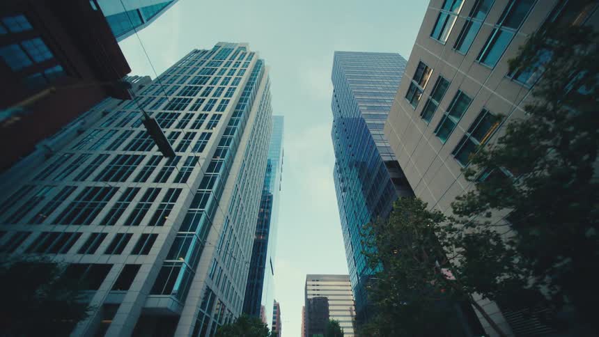 Windows look like mirrors on skyscrapers in a city