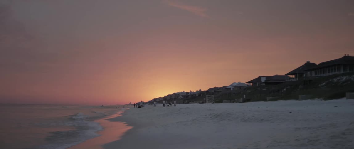 People are ahead on the beach at dawn