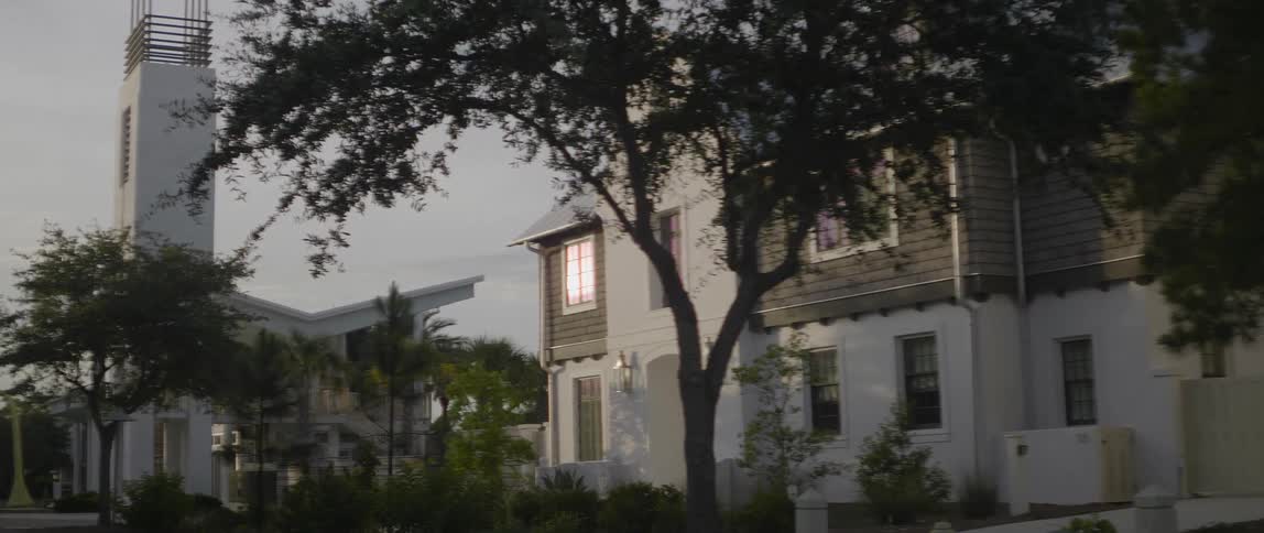 Light glaring off a house window at dusk