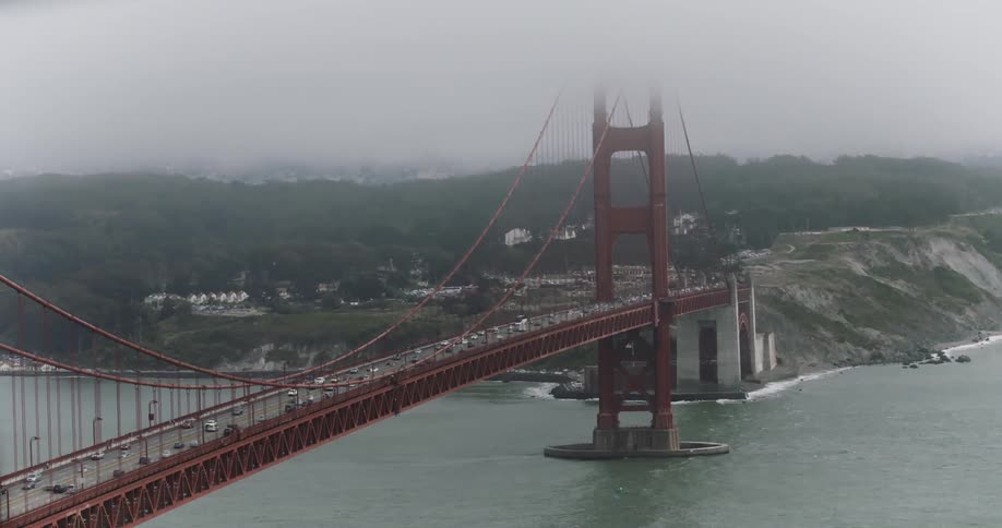 A famous red bridge with a lot of vehicles driving across it
