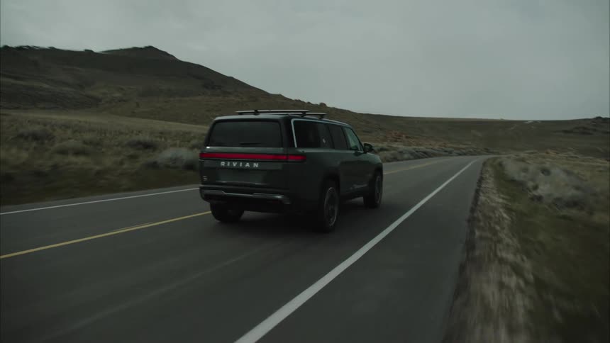 Person is driving a car through the wilderness in a rural area
