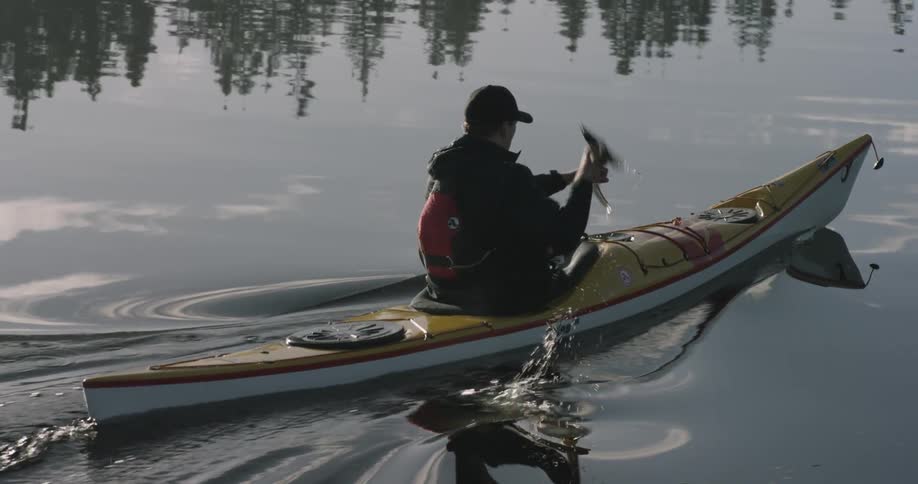 A man is rowing a canoe