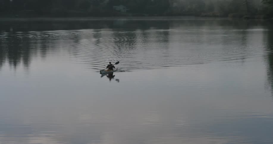 A person rowing a canoe on a body of water
