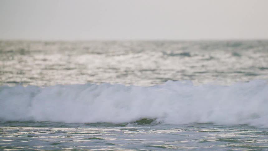 A man is playing in rough surf