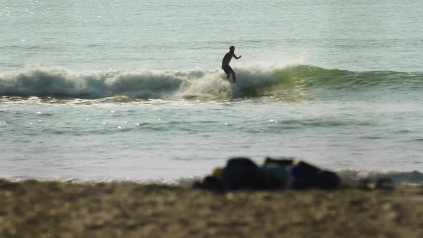 A man is surfing on ocean waves by himself