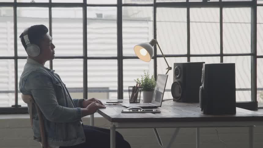 A footage of a man working on a laptop in an office