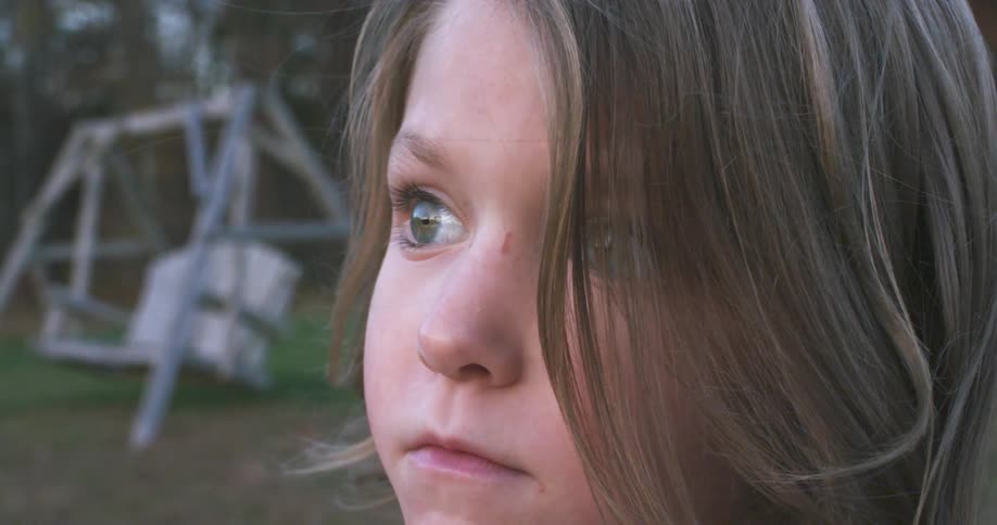 A young girl looks into the distance