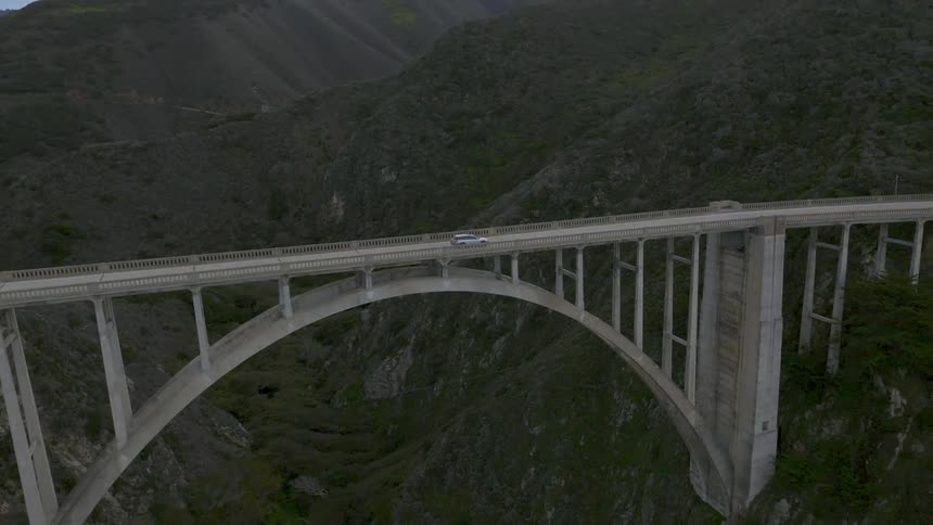 A vehicle crosses a long bridge