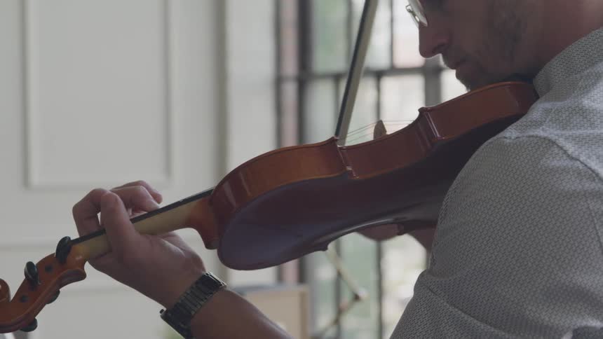 Man sways while playing his violin