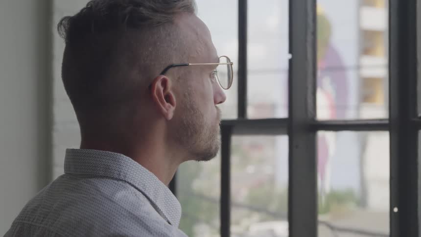 A man looks out the window