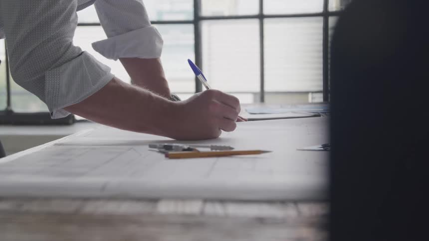 A footage of a person writing in the office
