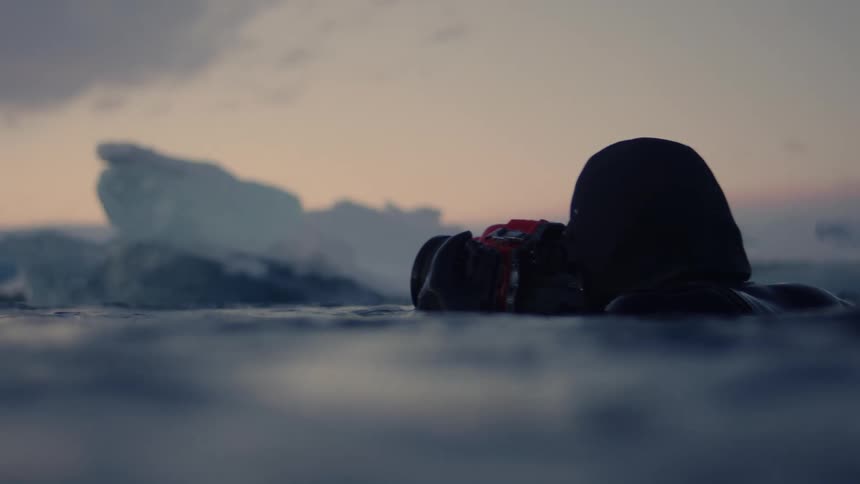 A man is photographing the floating ice