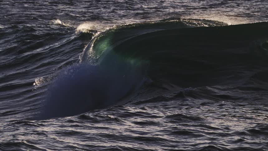 The wave slowly falls in the ocean