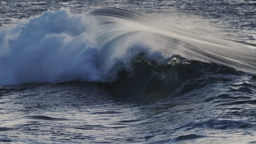 The small wave crashes in the ocean