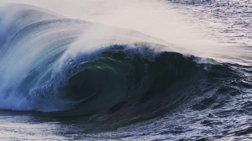 Large wave swells then creates a barrel while crashing