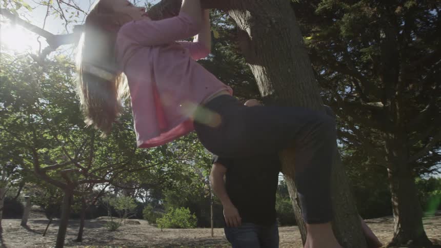 A kid climbing a tree