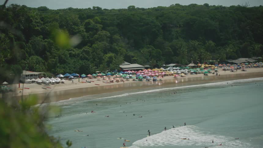 Tourists surfing sunbathing swimming while on vacation at a beach resort