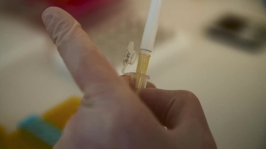 A footage of a person holding syringe