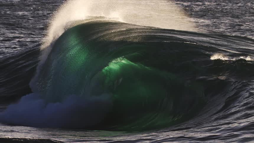 The large wave slowly forms in the ocean