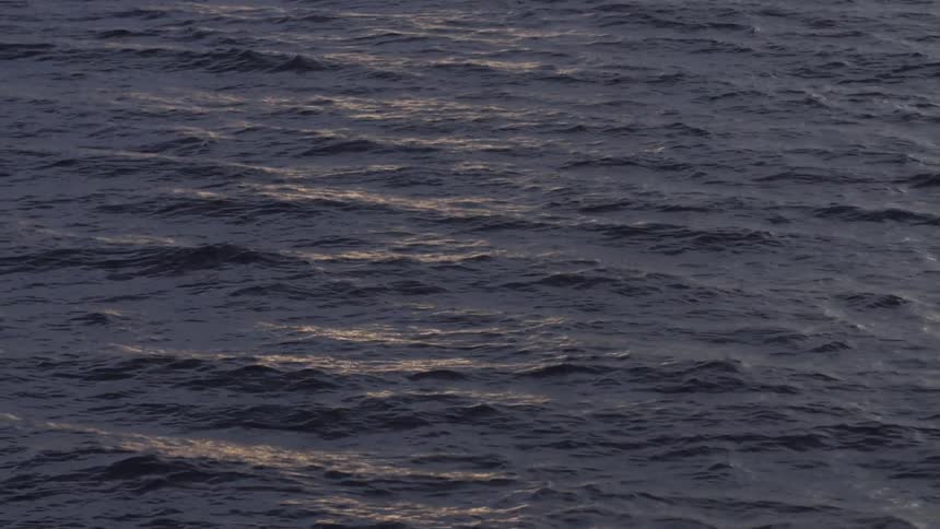 Body of water flowing in small rippling waves at dusk