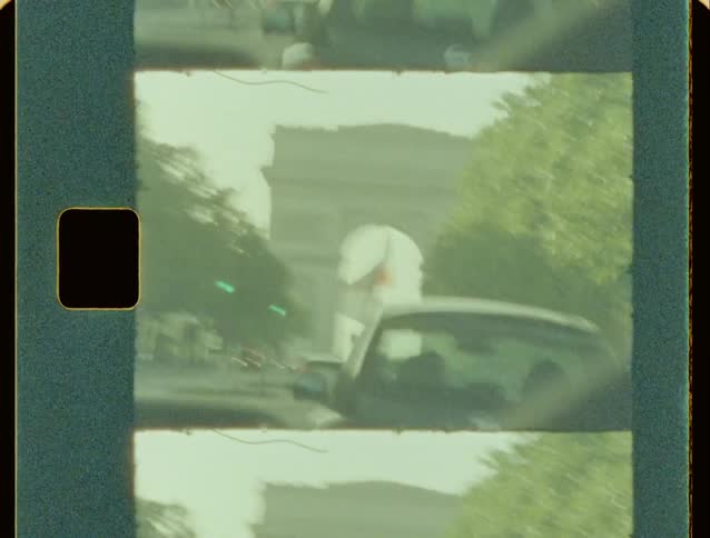 Cars are driving through a busy street during summer