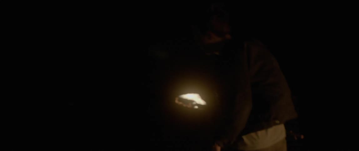 A man runs forward at night