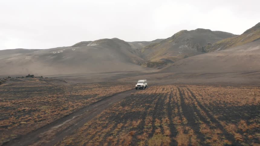 A aerial footage of a truck moving on the plain land