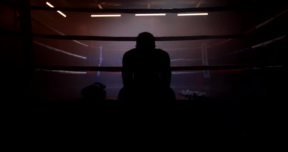 A footage of a person sitting outside a boxing ring