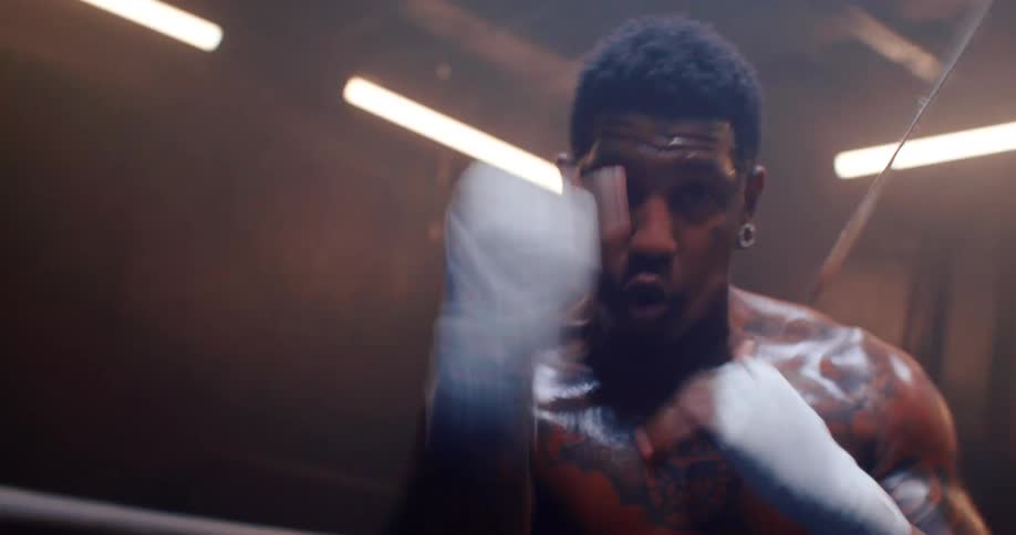 A boxer is dodging and shadowboxing in the ring