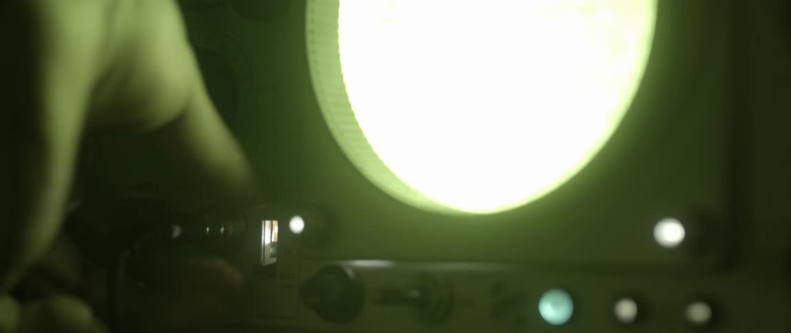 A person is turning knobs on a machine