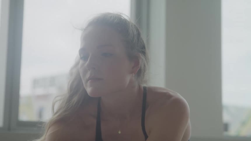 A woman is stretching in the room