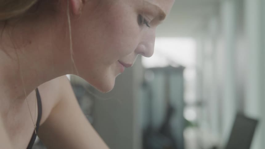 A woman is exercising on a machine inside of a gym