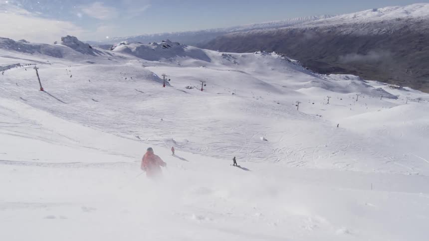 Skier descends a snowy mountain