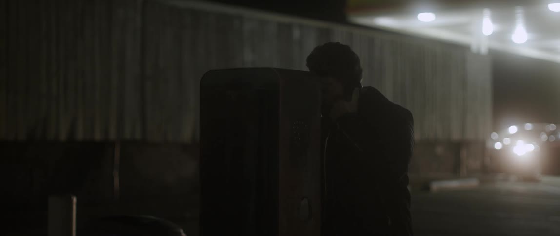 A man looks around before picking up the phone