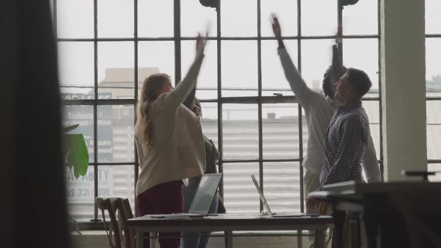 Employees cheer in the office together