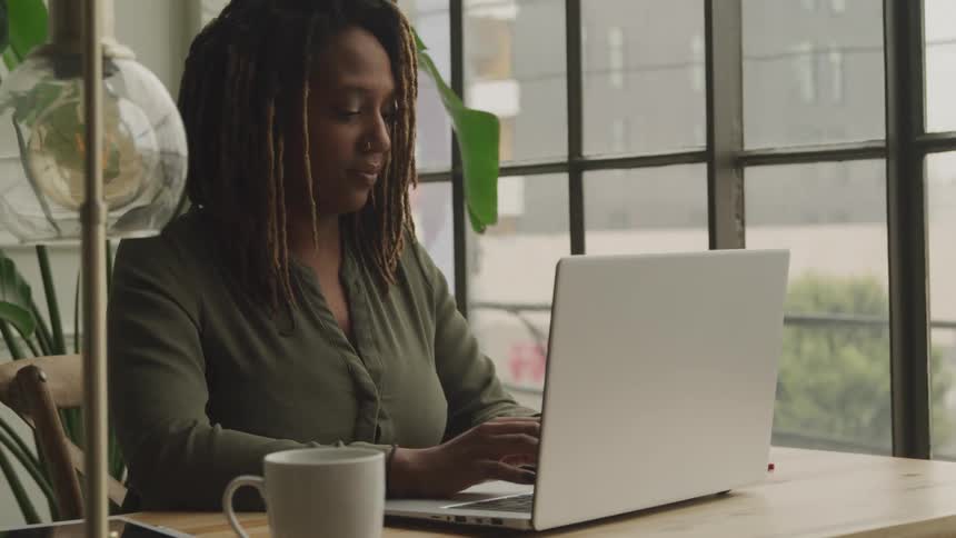 Black girl typing on computer
