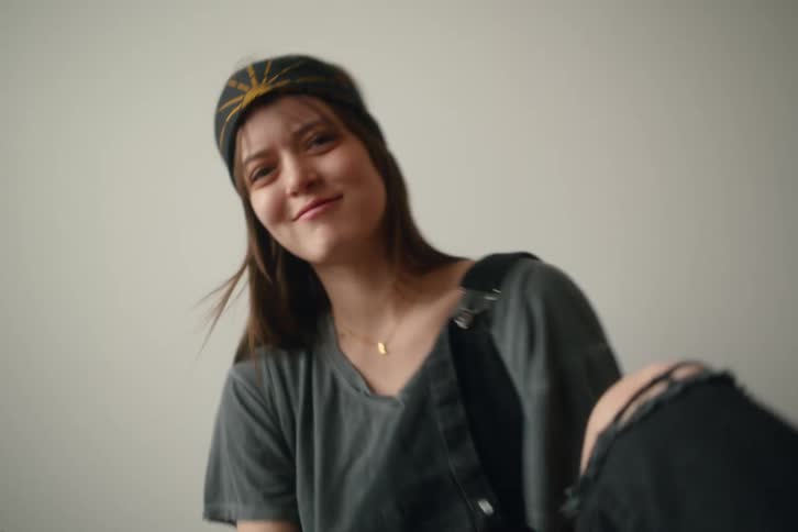 A woman sits in the room