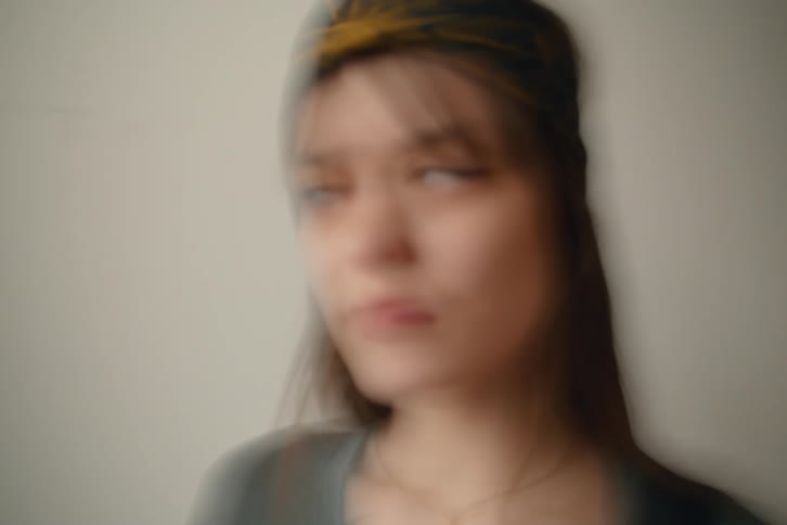A woman looks off to the side