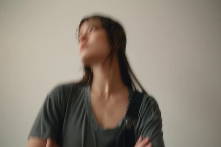 The model looks off to the side while posing