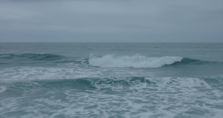 Heavy clouds hang over the ocean