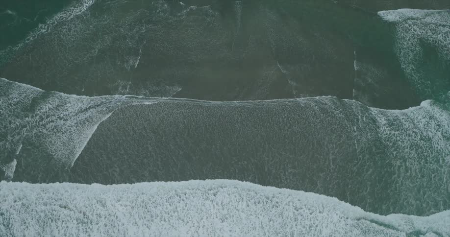 The water recedes on the sand