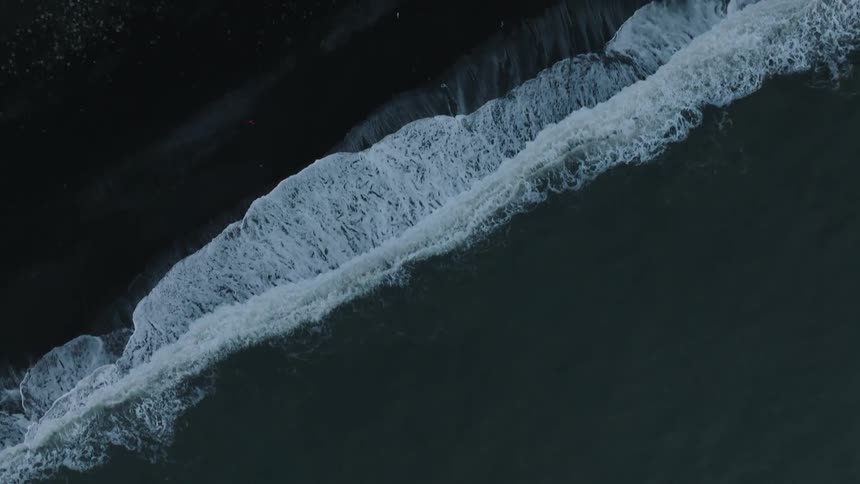 Waves crash on the rocks of the shore