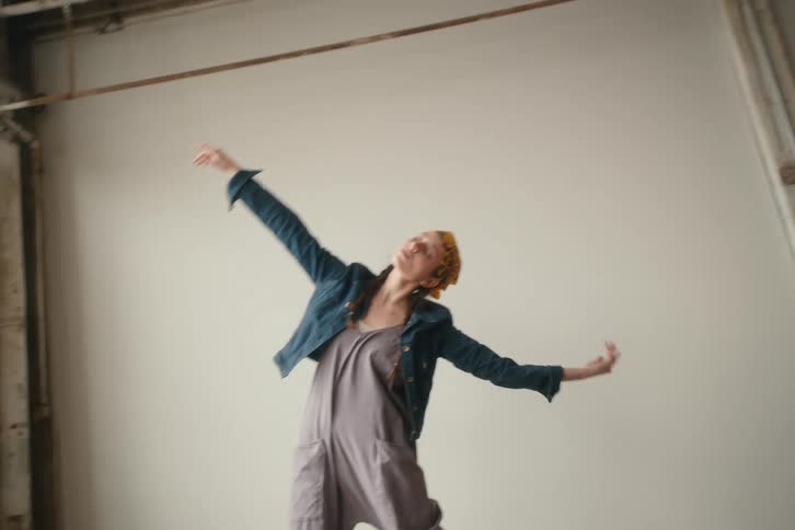 A woman is stretching by the wall