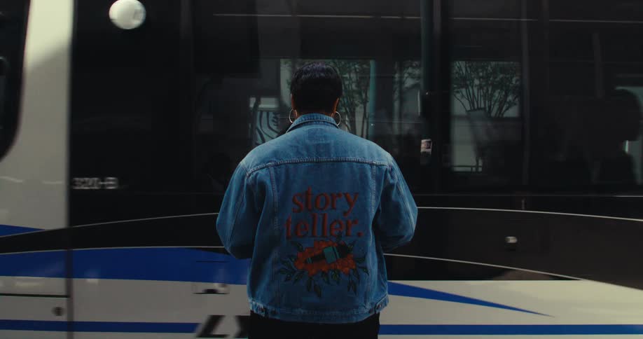 A footage of a lady standing at the train terminal