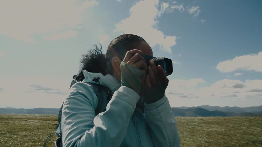 A photographer taking a picture in a field